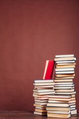 stacks of books for reading and education on a brown background in the library