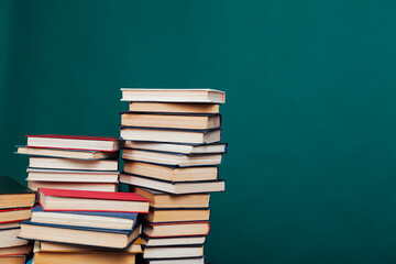 stacks of books for reading and education on a green background in the university library