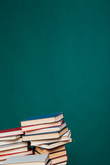 stacks of books for reading and education on a green background in the university library