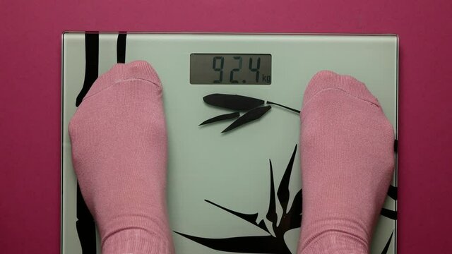 Girl steps onto the bathroom scale, overweight fears her and she drops cream tart, The problem of overeating, managing weight, inability to stint oneself in food