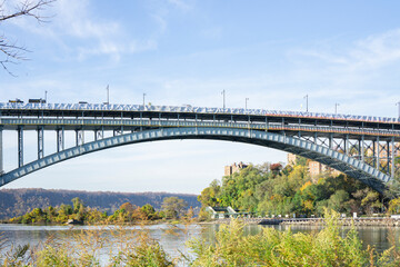 view on a bridge and water with trees surrounding the apartment buildings