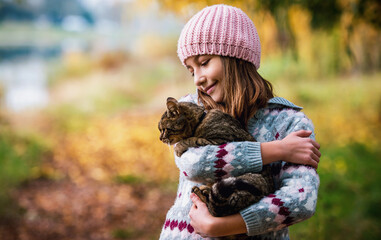 Little girl with a cat. Pets and animals concept