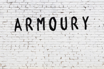 Inscription armoury painted on white brick wall