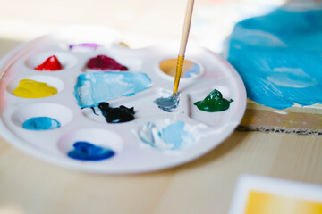 Artist palette with acrylic paints of different colors