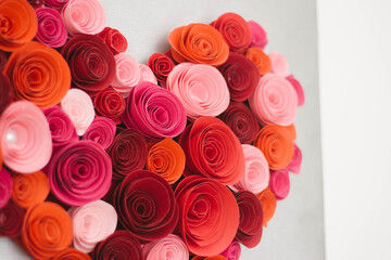 Red paper roses making the shape of a heart close up