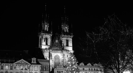 Cathedral towers and Christmas tree decorated by lights and comete, in Old Town Prague, Advent pediod