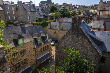 Fototapeta na wymiar Dinan, France - August 26, 2019: High angle view of Dinan with old cobblestoned streets and stone medieval houses, French Brittany
