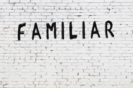 White wall with black paint inscription familiar on it