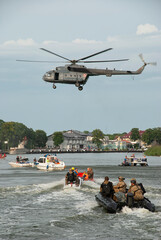 Commandos on boats under the Mi-8 helicopter. The photo was taken during a public show, where...