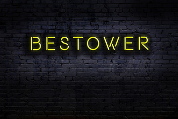 Night view of neon sign on brick wall with inscription bestower