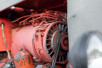 Closeup of red tractor fuel injectors four cylinder diesel engine details on sharp focus in rural Bulgarian region in autumn