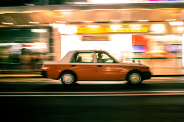 Fototapeta na wymiar fast moving taxi in Kyoto, real motion blur effect