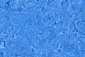 Liquid blue paint on white paper abstract background