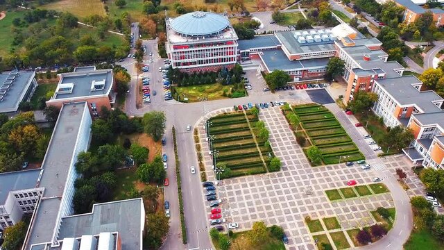 Aerial drone view of university campus among greenery and dwelling houses. Bucharest, Romania