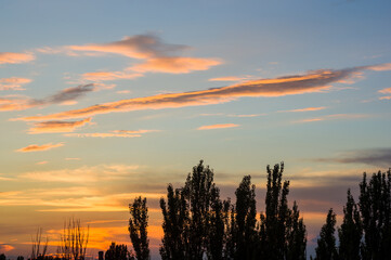 Landscape with dramatic light - beautiful golden sunset with saturated sky and clouds.