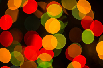 Christmas background-garlands with colorful lights on a decorated Christmas tree, bokeh, blurred