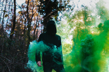 Black figure with green smoke