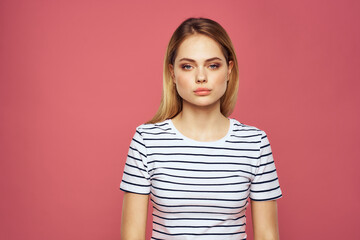 Obraz premium Cheerful woman striped t-shirt lifestyle emotions and gestures with hands pink background