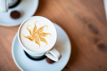 Latte-art in the cup of coffee on the coffeeshop