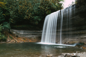Fototapeta na wymiar Bridal Veil Falls on Manitoulin island. A 35 ft high photogenic waterfall during fall