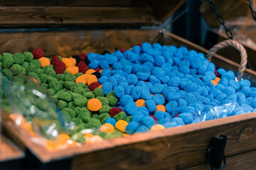 Assortment of colorful delicious marmalade jelly candies for sale on counter of shop, grocery, market, cafe. Dessert, sweet food and confectionery concept