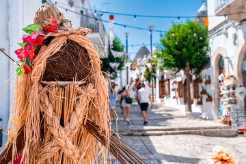 Human sculpture traditional trulli houses in Arbelobello, province Bari, region Puglia, Italy....