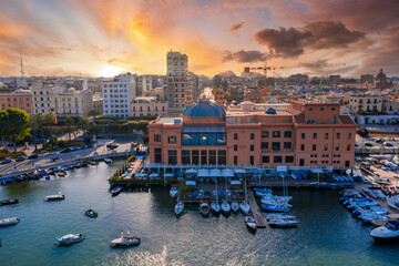 Beautiful panoramic aerial view photo from flying drone at sunset to Bari Apulia City port boats...