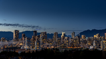 Obraz premium Night Sky of the Skyline of Downtown Vancouver, British Columbia, Canada. Viewed from the South Shore of Falls Creek