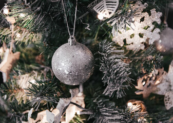 Closeup of beautiful silver ornaments on a festive Christmas tree