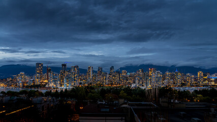 Fototapeta na wymiar Night Sky of the Skyline of Downtown Vancouver, British Columbia, Canada. Viewed from the South Shore of Falls Creek