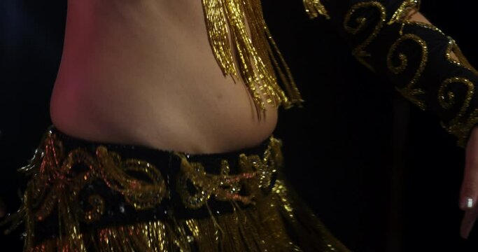 Woman belly dancing in stylish traditional clothing and jewellery - slow motion