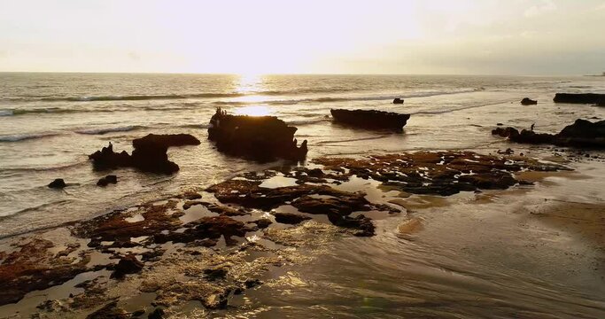 Drone video of beach coastline in Bali at sunset.