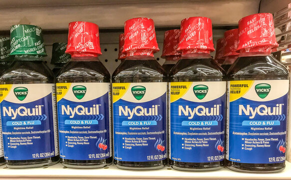 Bottles of NyQuil on a shelf at a store. 