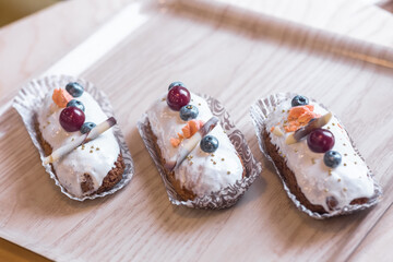 three eclairs with custard in a bakery