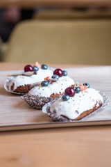 three eclairs with custard in a bakery