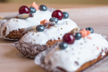 three eclairs with custard in a bakery