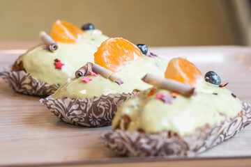 three eclairs with custard in a bakery