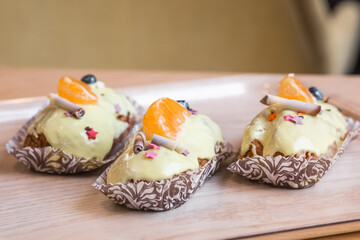 three eclairs with custard in a bakery