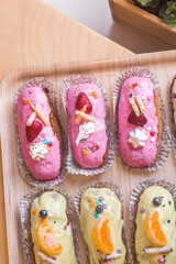 three eclairs with custard in a bakery