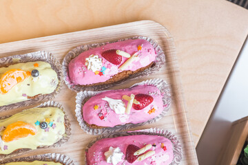 three eclairs with custard in a bakery