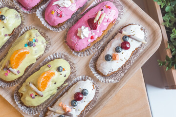 three eclairs with custard in a bakery