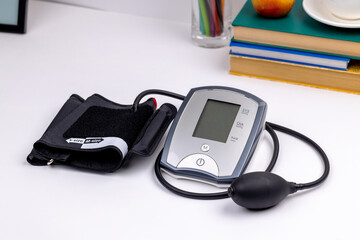 male person measuring blood pressure by using electronic medical monitor. employee overworked...