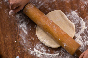 rolling pin and rolled dough on the table