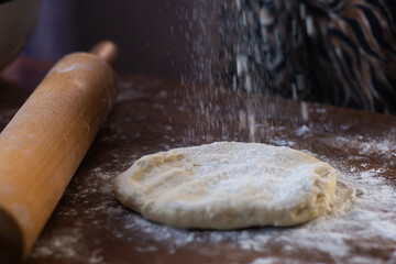 rolling pin and rolled dough on the table