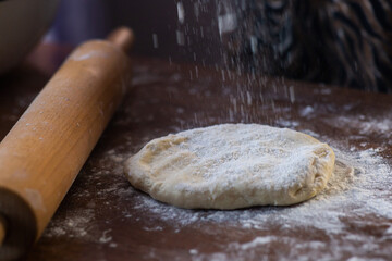 rolling pin and rolled dough on the table