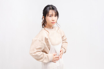 Obraz premium お腹に手を当てる若い女性