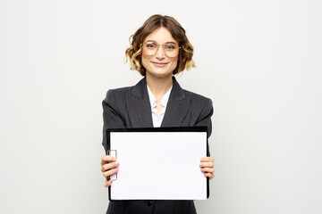 Business woman with a folder of documents on a light background cropped view and shirt suit