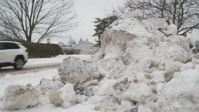 High Snowbanks In Residential Neighbourhood During Winter