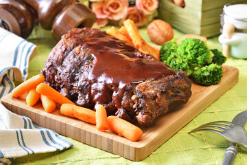 Grilled and smoked pork ribs with barbeque sauce on a wooden board. 