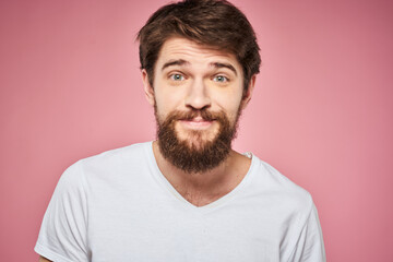 Fototapeta premium Man in white t-shirt emotions lifestyle facial expression cropped view pink background.
